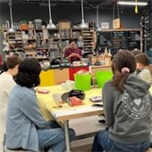 Teens listen to a local scientist discuss their job.