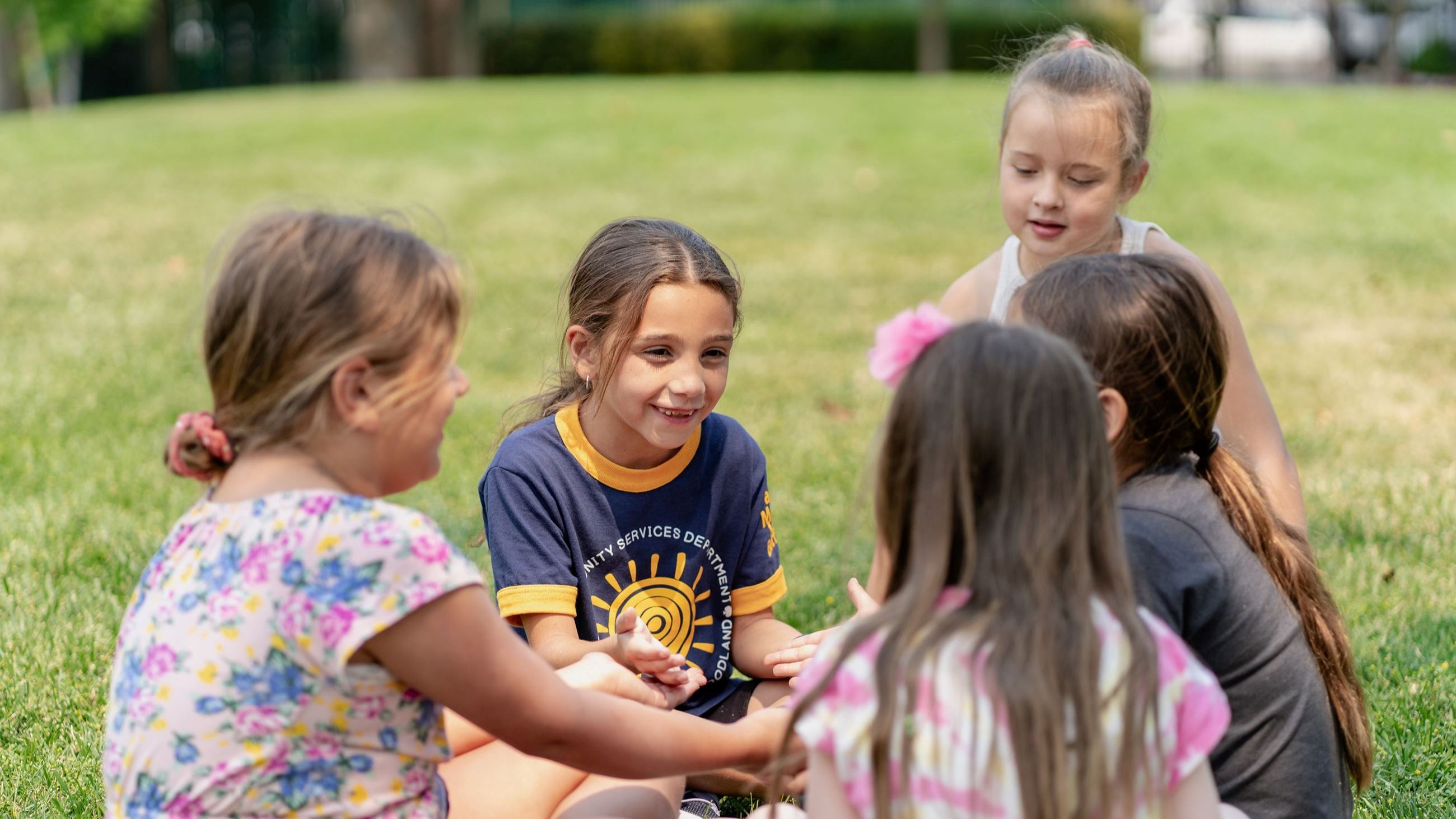 Children sitting in a circle playing a game