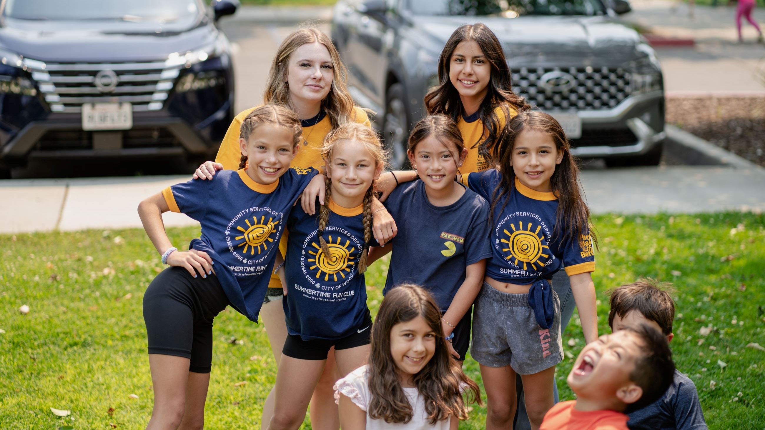 Group of 9 children huddled together smiling